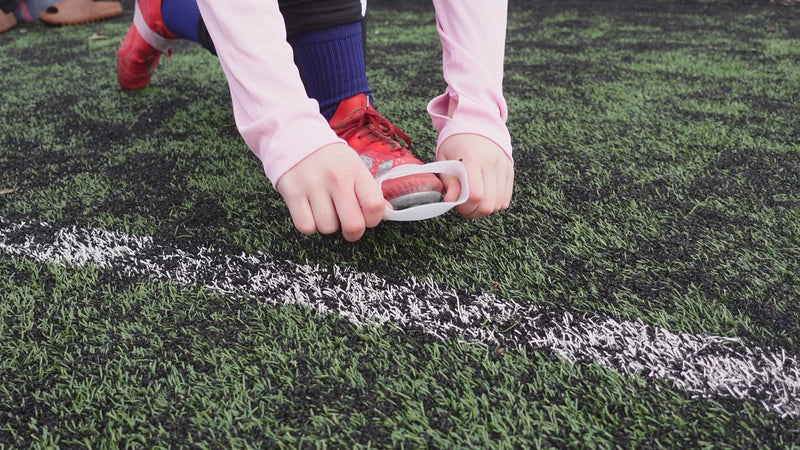 Translucent Laceeze band covering a football boot