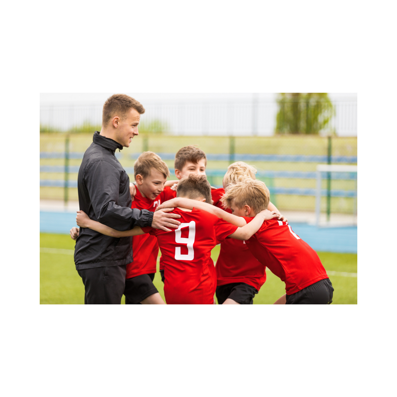 young football players in a huddle with their coach 